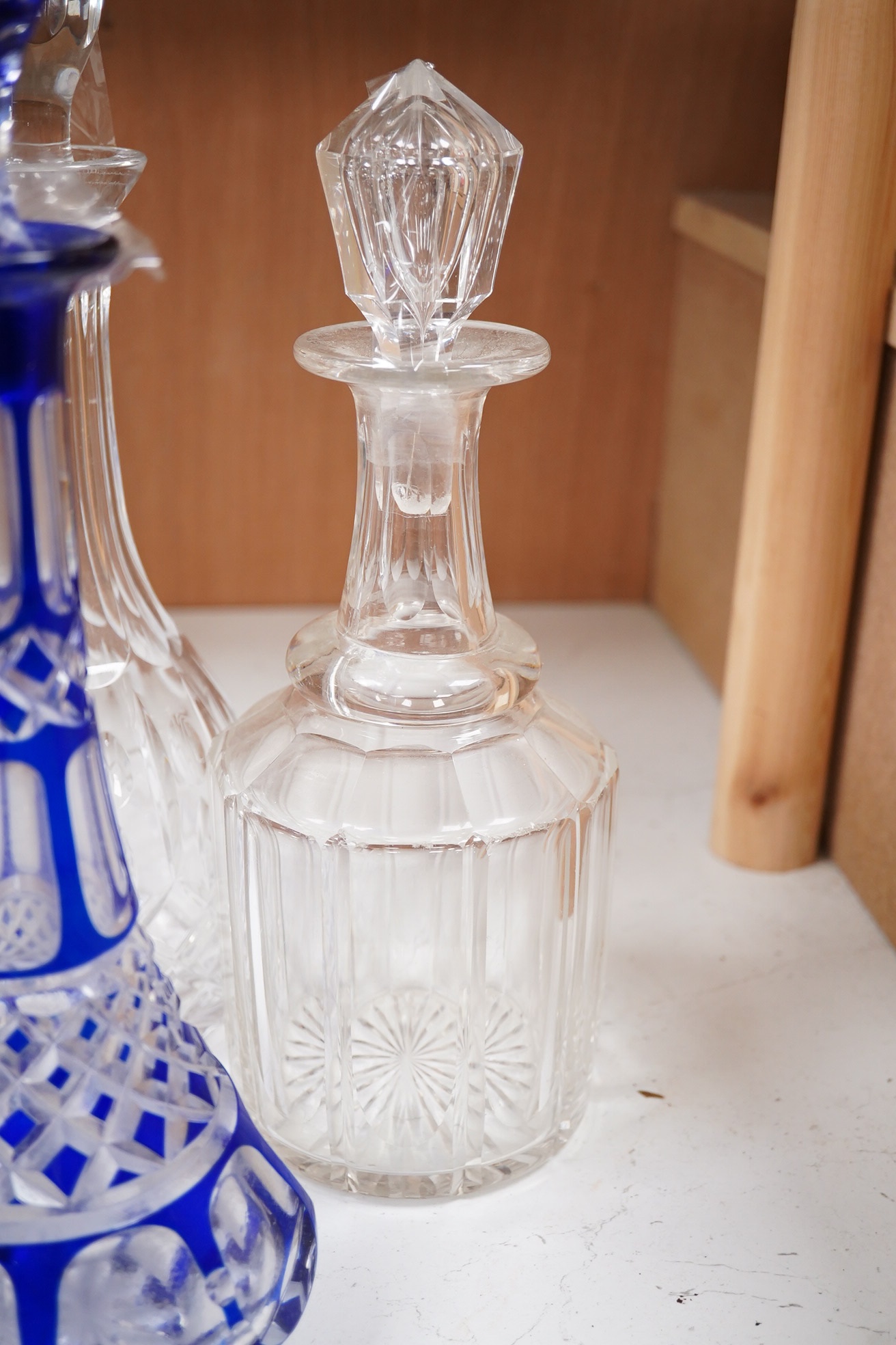 A near pair of blue flashed decanters and stoppers and four other decanters and stoppers, tallest blue flash decanter and stopper, 34cm high (6). Condition - fair to good